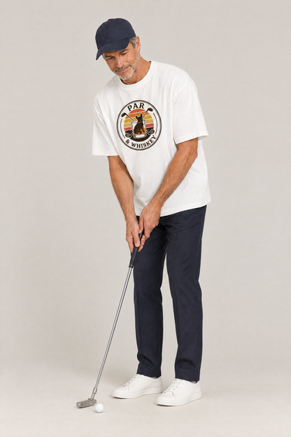 Man lining up a putt in the white Par & Whiskey French Bulldog Badge Golf Tee. Color: White