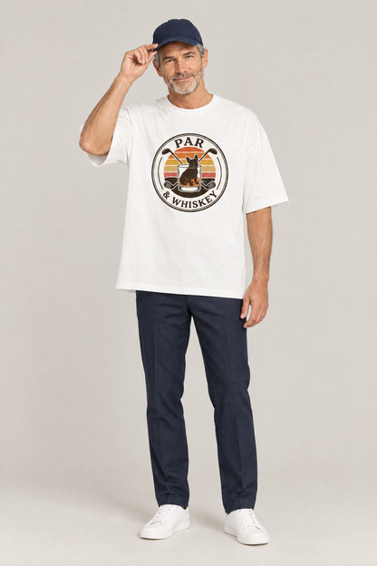 Man wearing the Par & Whiskey French Bulldog Badge Golf Tee in white with navy trousers and a navy cap. Color: White