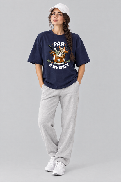 Woman wearing the Par & Whiskey French Bulldog Splash Golf Tee in navy with light grey trousers and a white cap. Color: Navy