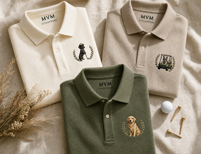 Folded embroidered dog polo shirts with golf tees on cream linen
