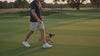Man wearing a premium dog-themed t-shirt while walking outdoors in a lifestyle setting.
