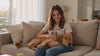 Smiling woman wearing a premium dog-themed t-shirt while relaxing with her dog at home.