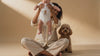 Personalized baby bodysuit featuring a custom dog design, shown with a baby and family pet.