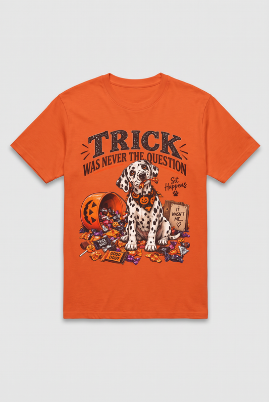 Flat lay of an orange Dalmatian Halloween t-shirt with a candy thief puppy and the text Trick Was Never The Question