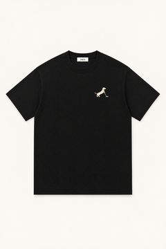 Black Putting dachshund golf t-shirt laid flat, front view on warm off-white background. Color: Black