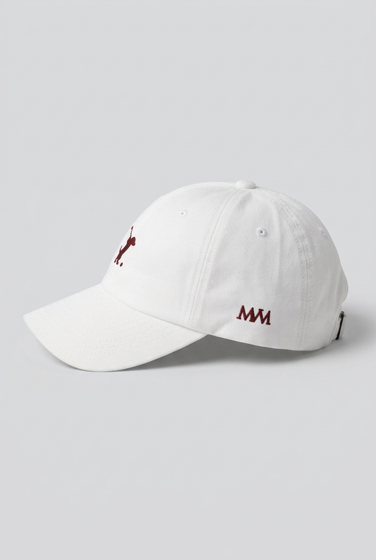 Color: White. Golf cap, angled side view with burgundy Swing dachshund and MVM monogram