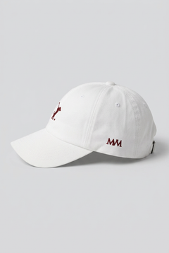 Color: White. Golf cap, angled side view with burgundy Swing dachshund and MVM monogram