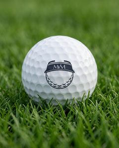 Visor Ball golf ball in navy and cream print, close-up on green grass