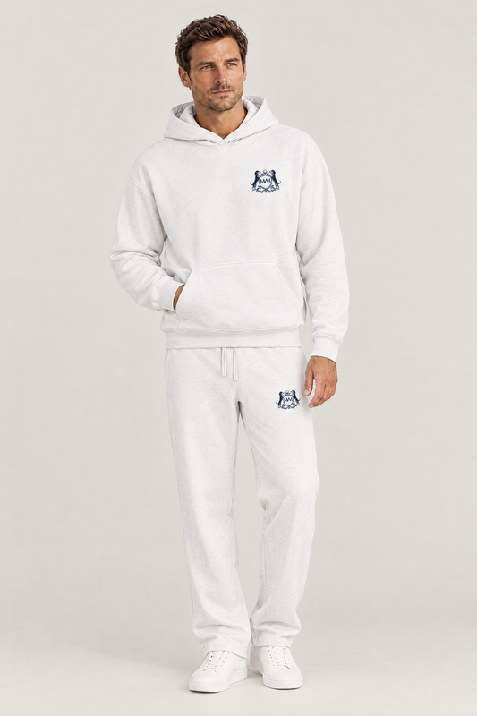 Man wearing the white Club Crest hoodie and sweatpants with the small navy Golf & Dachshund Club crest, full body