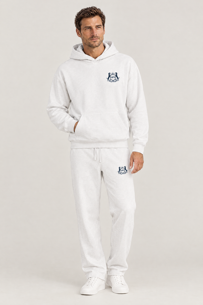 Man wearing the white Club Crest hoodie and sweatpants with the small navy Golf & Dachshund Club crest, full body