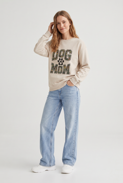 Woman wearing the Camo Dog Mom sweatshirt in sand, three-quarter view. Color: Sand