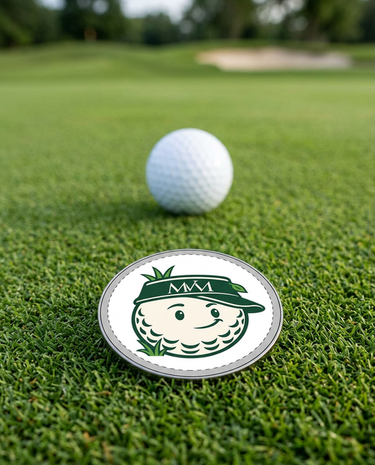 Rough Day golf ball marker in forest green and cream print on a putting green next to a golf ball