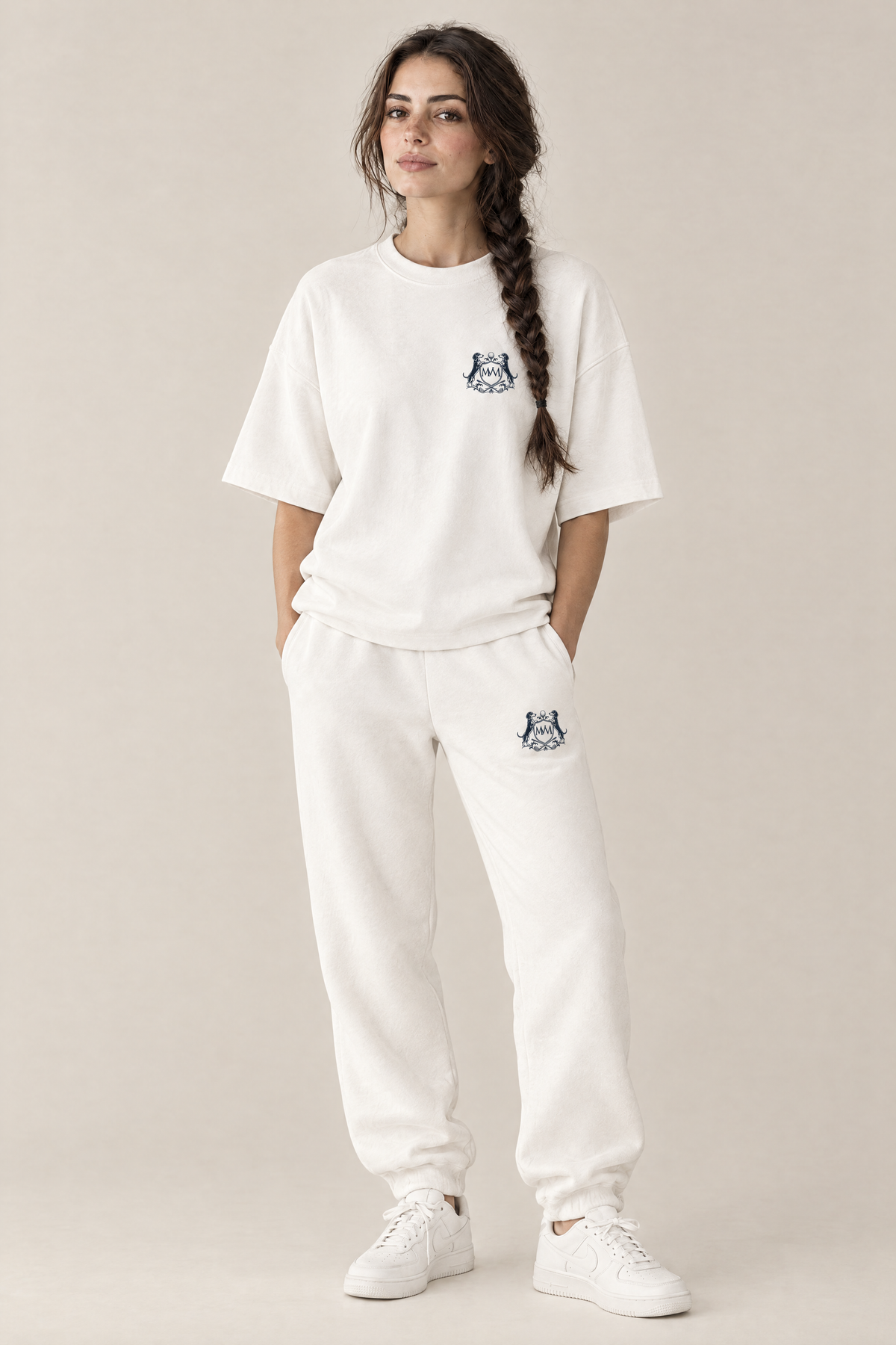 Woman in a white oversized Club Crest tee and matching white sweatpants, full body, tone-on-tone set