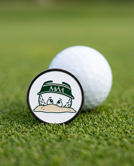 Bunker Buddy golf ball marker in forest green and cream print on a putting green next to a golf ball