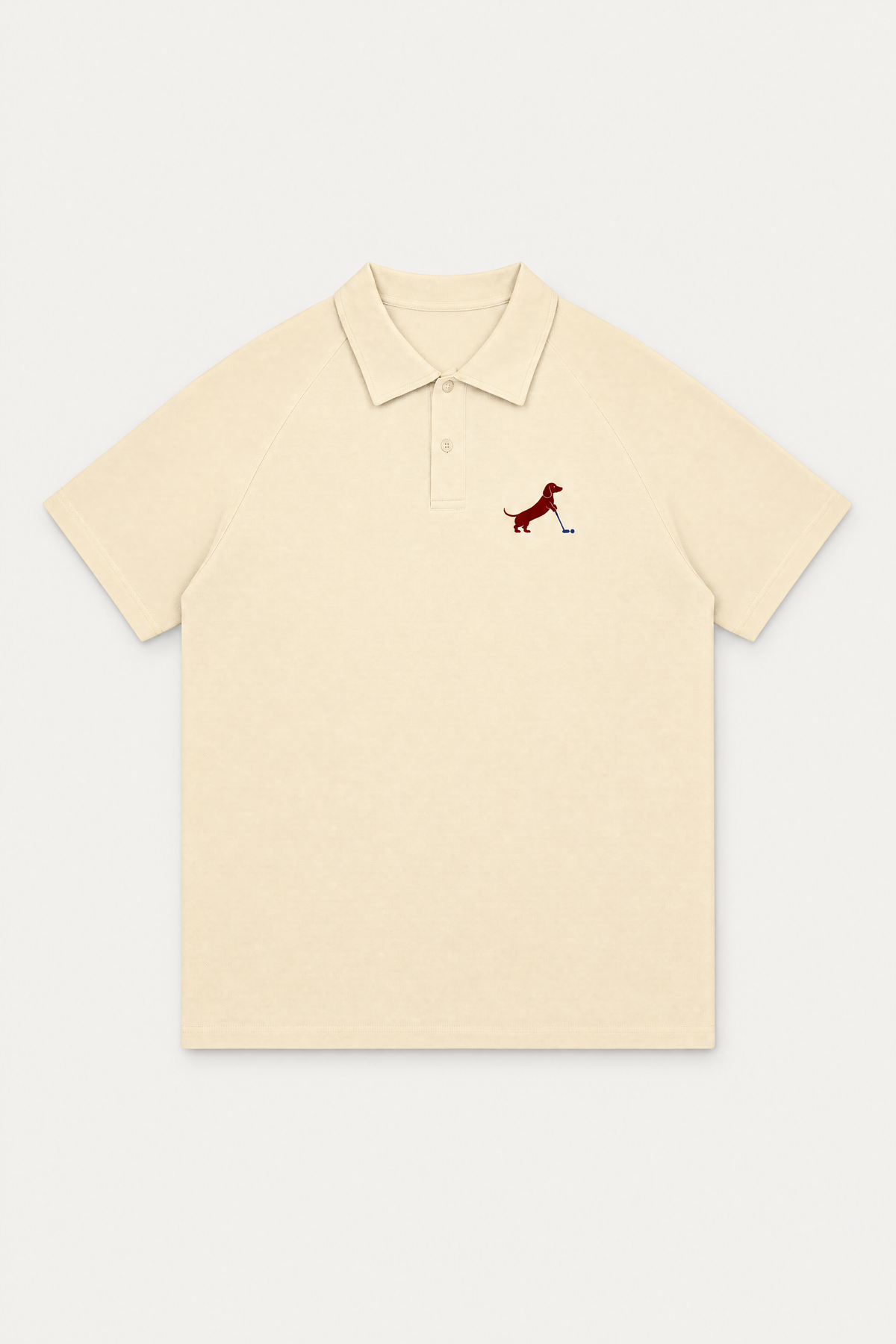 Apricot Putting dachshund golf polo laid flat, front view on warm off-white background. Color: Apricot