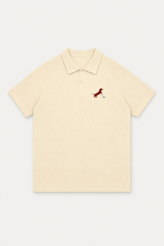 Apricot Putting dachshund golf polo laid flat, front view on warm off-white background. Color: Apricot