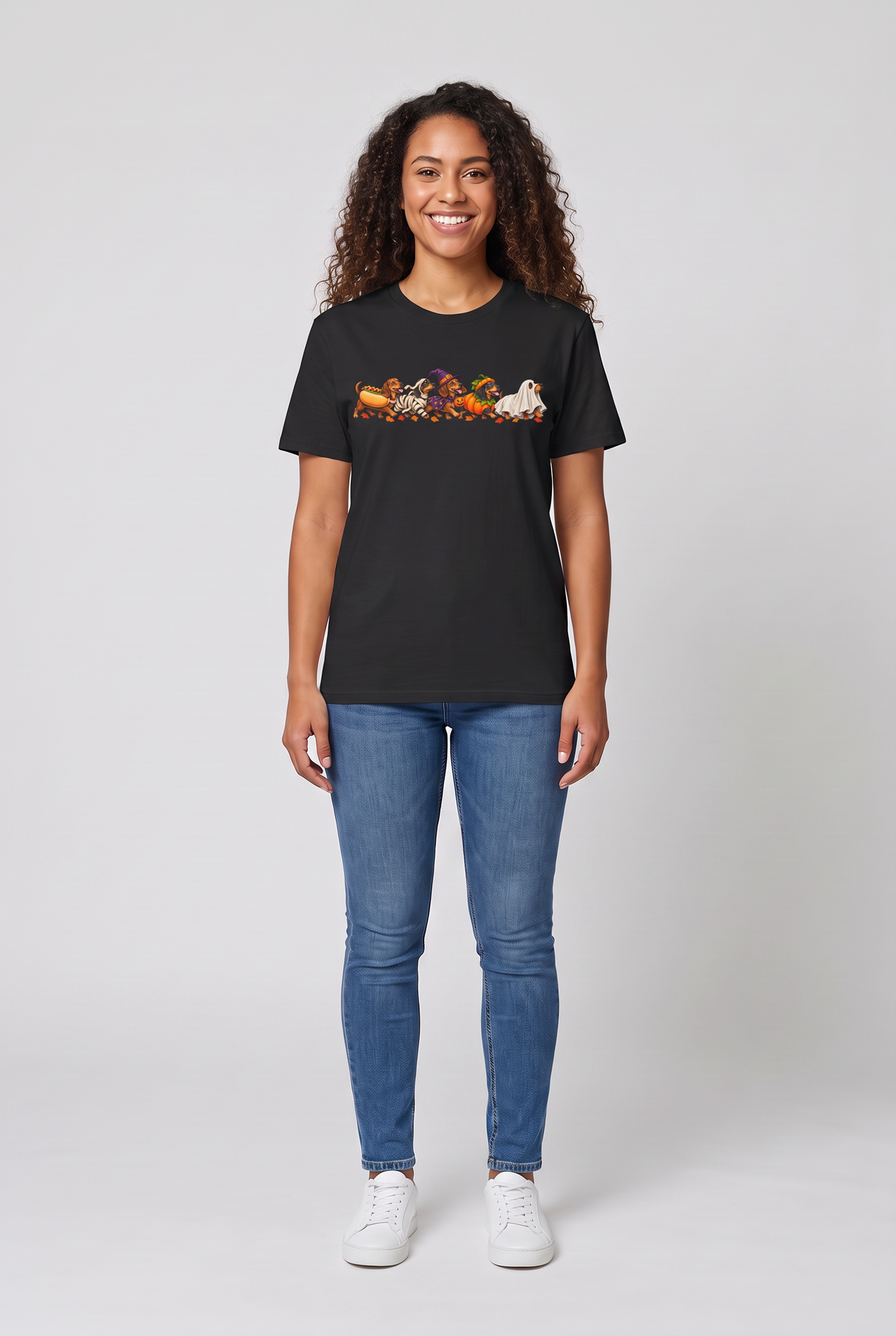 Woman wearing a black wiener dog Halloween parade t-shirt with five dachshunds dressed as hot dog, mummy, witch, pumpkin and ghost, front view
