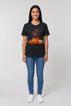 Frau trägt ein Dackel Hexen Halloween T-Shirt in Schwarz mit Dackel in Hexenhut und Umhang auf einer leuchtenden Kürbislaterne, Vorderansicht