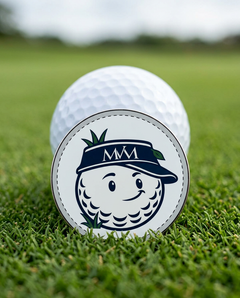 Rough Day golf ball marker in navy and cream print on a putting green next to a golf ball