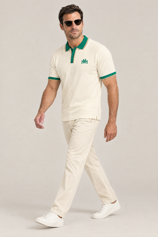 Man walking in the Club Crest color block polo in apricot with green trim, cream chinos and sunglasses. Color: Apricot with Green