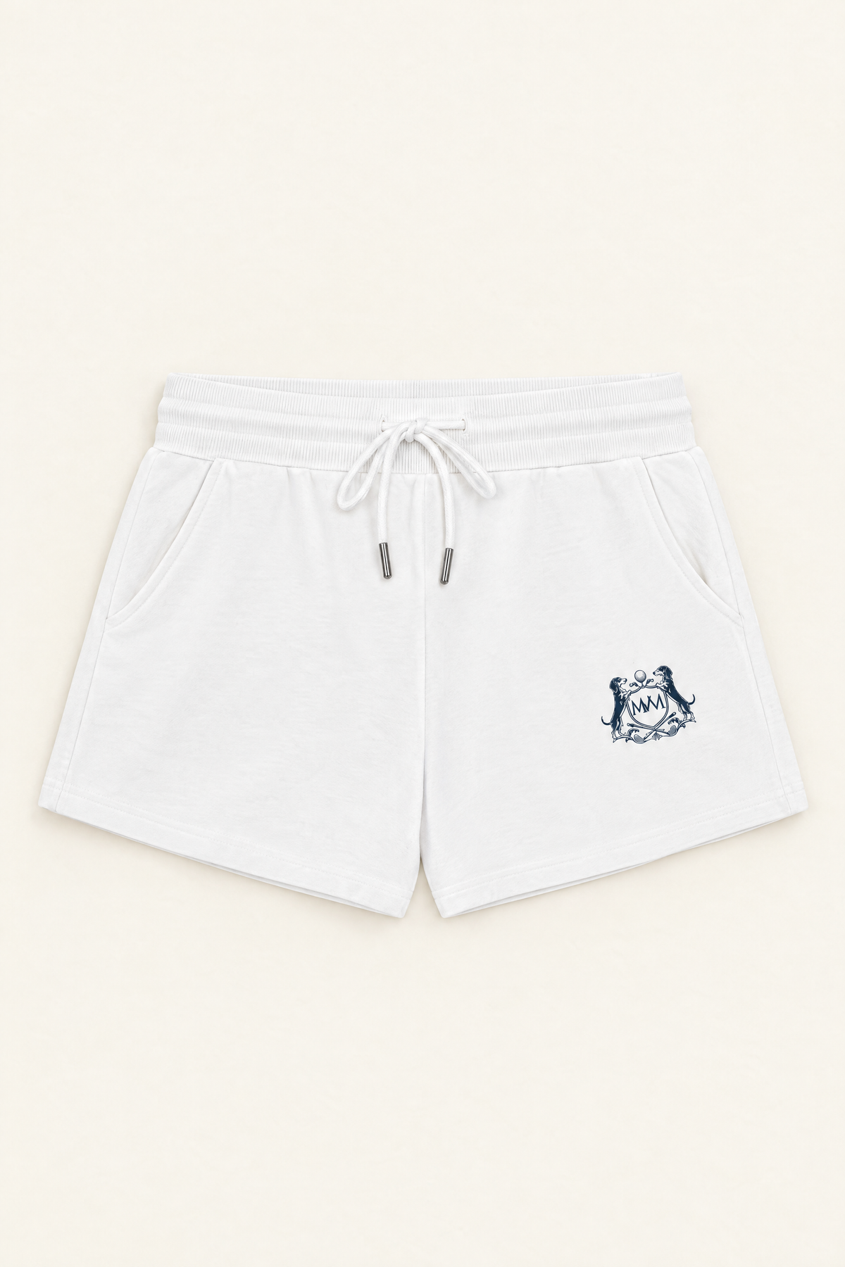 Flat lay of white drawstring Club Crest shorts with the small navy crest on the upper thigh. Color: White