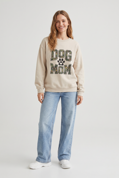 Woman wearing the Camo Dog Mom sweatshirt in sand, front view. Color: Sand