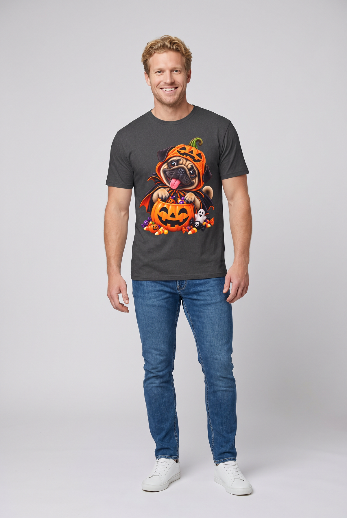 Man wearing a dark heather pug Halloween t-shirt with a pug in a pumpkin costume and candy bucket, front view
