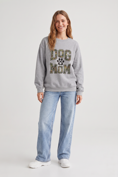 Woman wearing the Camo Dog Mom sweatshirt in sport grey, front view. Color: Sport Grey