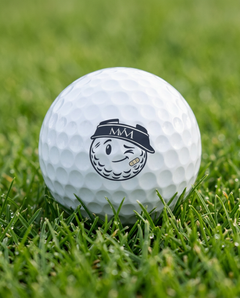 Mulligan golf ball in navy and cream print, close-up on green grass