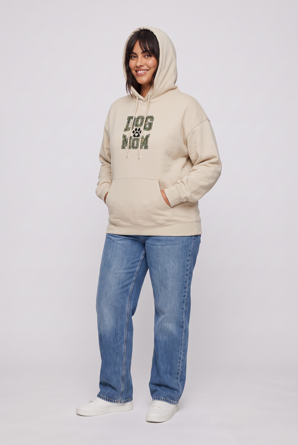 Woman wearing the Camo Dog Mom hoodie in sand, three-quarter view. Color: Sand