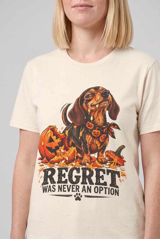 Close-up of the chest print on a natural funny dachshund Halloween t-shirt with a wiener dog next to a smashed jack-o-lantern and the text Regret Was Never An Option
