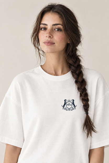 Woman wearing the white Club Crest tee, close-up of the small navy Golf & Dachshund Club crest at the left chest