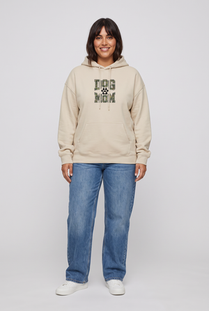 Woman wearing the Camo Dog Mom hoodie in sand, front view. Color: Sand