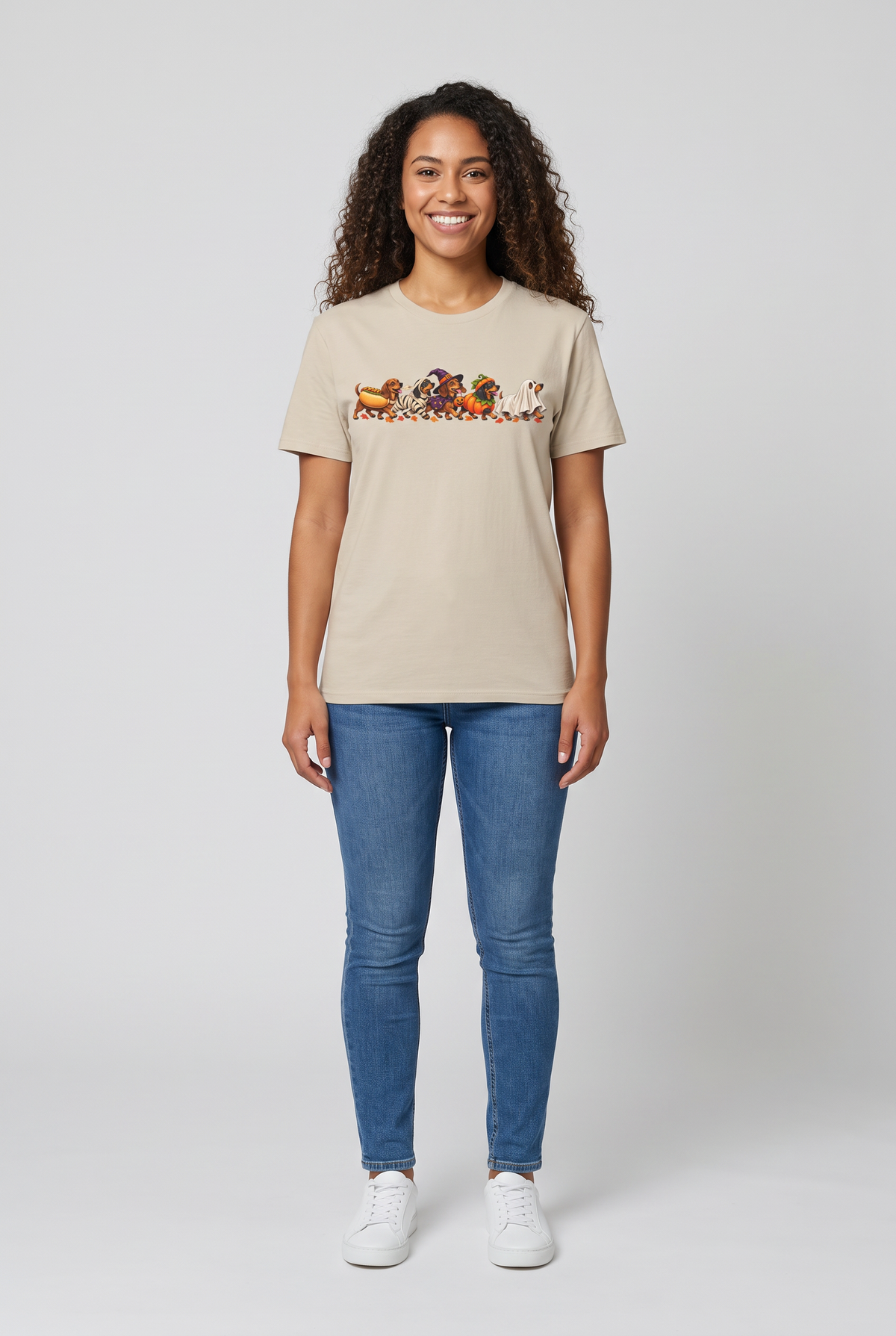 Woman wearing a sand wiener dog Halloween parade t-shirt with five dachshunds dressed as hot dog, mummy, witch, pumpkin and ghost, front view