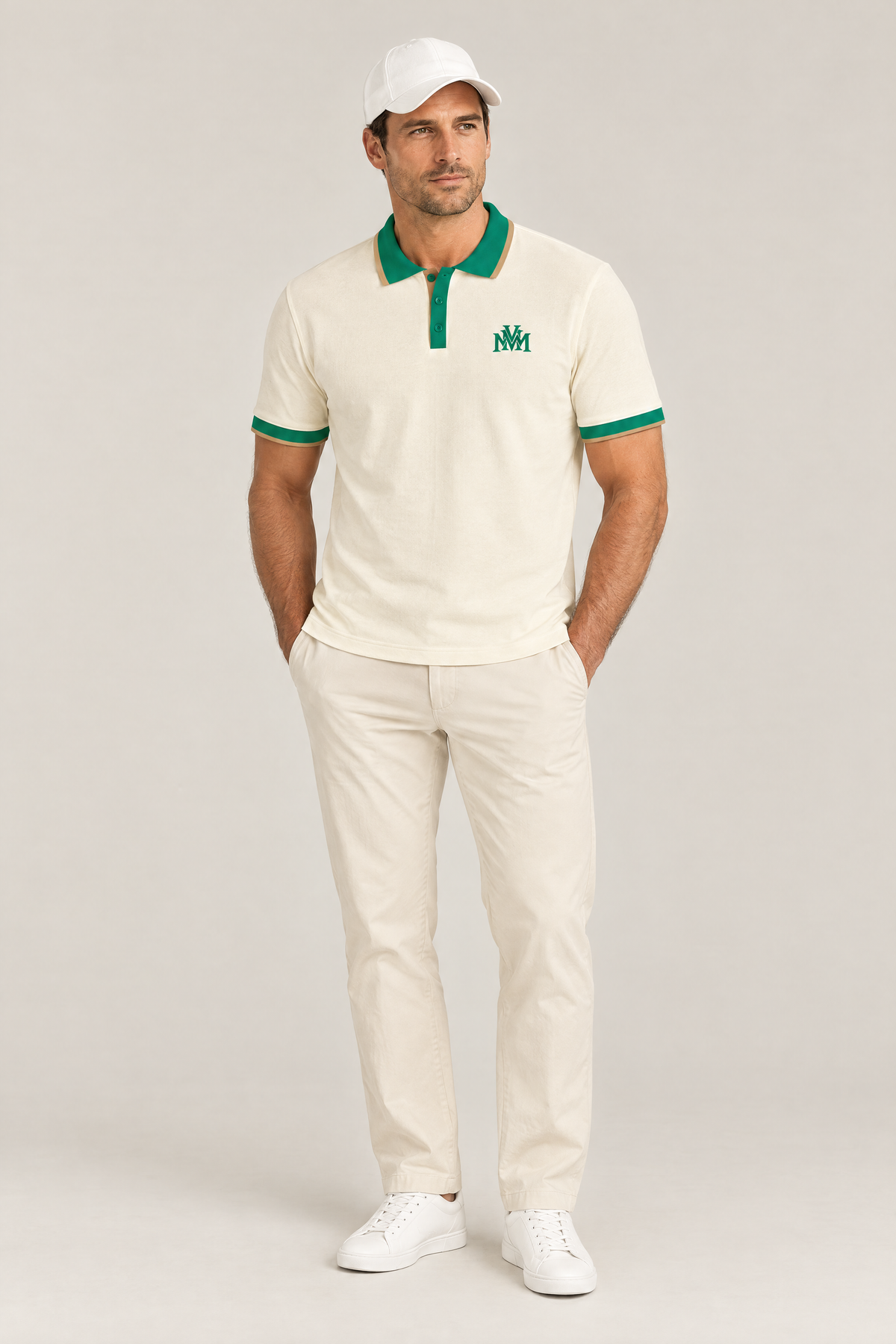 Man wearing the Club Crest color block polo in apricot with green trim, hands in pockets and a white cap. Color: Apricot with Green