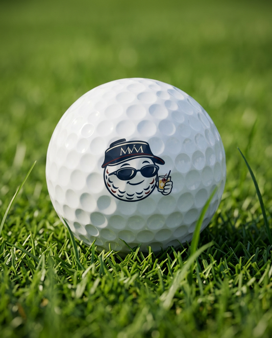 19th Hole golf ball in navy and burgundy print, close-up on green grass