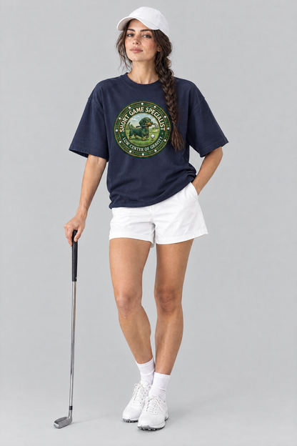 Woman wearing the Short Game Crest Dachshund Golf Tee in navy with white golf shorts and a white cap. Color: Navy