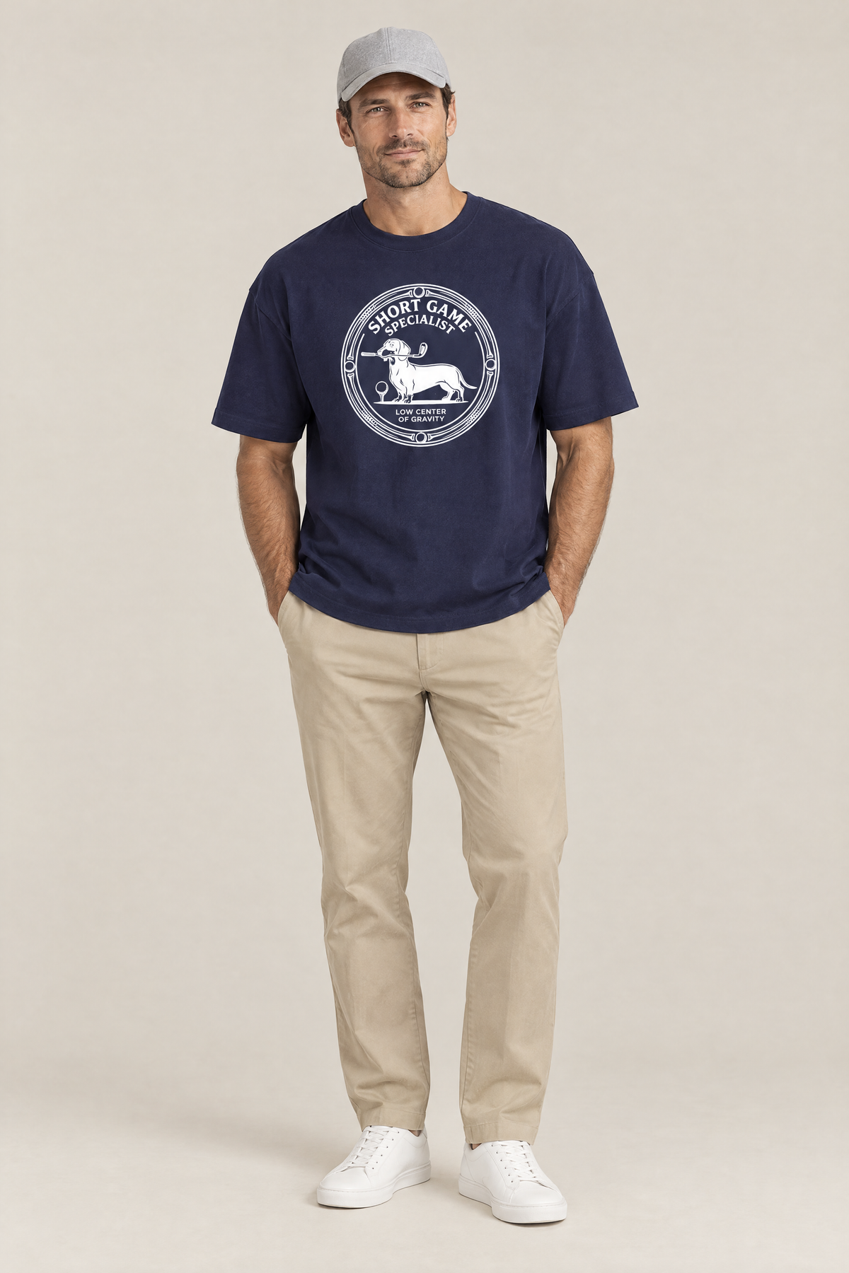 Man wearing the Short Game Specialist Dachshund Golf Tee in navy with khaki trousers and a grey cap. Color: Navy