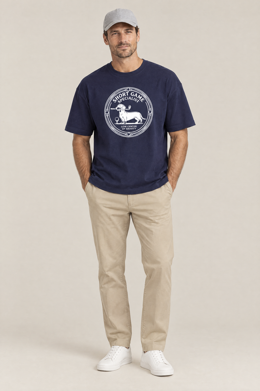 Man wearing the Short Game Specialist Dachshund Golf Tee in navy with khaki trousers and a grey cap. Color: Navy