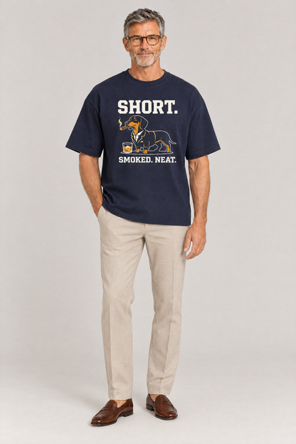 Man in glasses wearing the Short Smoked Neat Dachshund Tee in navy with beige trousers and loafers. Color: Navy