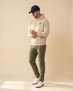 Man wearing Club & Swing dachshund golf hoodie, full-body studio look. Color: Apricot