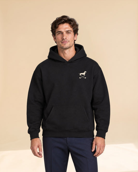 Man wearing Club & Swing dachshund golf hoodie, front studio view. Color: Black