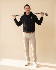 Man wearing Club & Swing dachshund golf hoodie, full-body studio look. Color: Black
