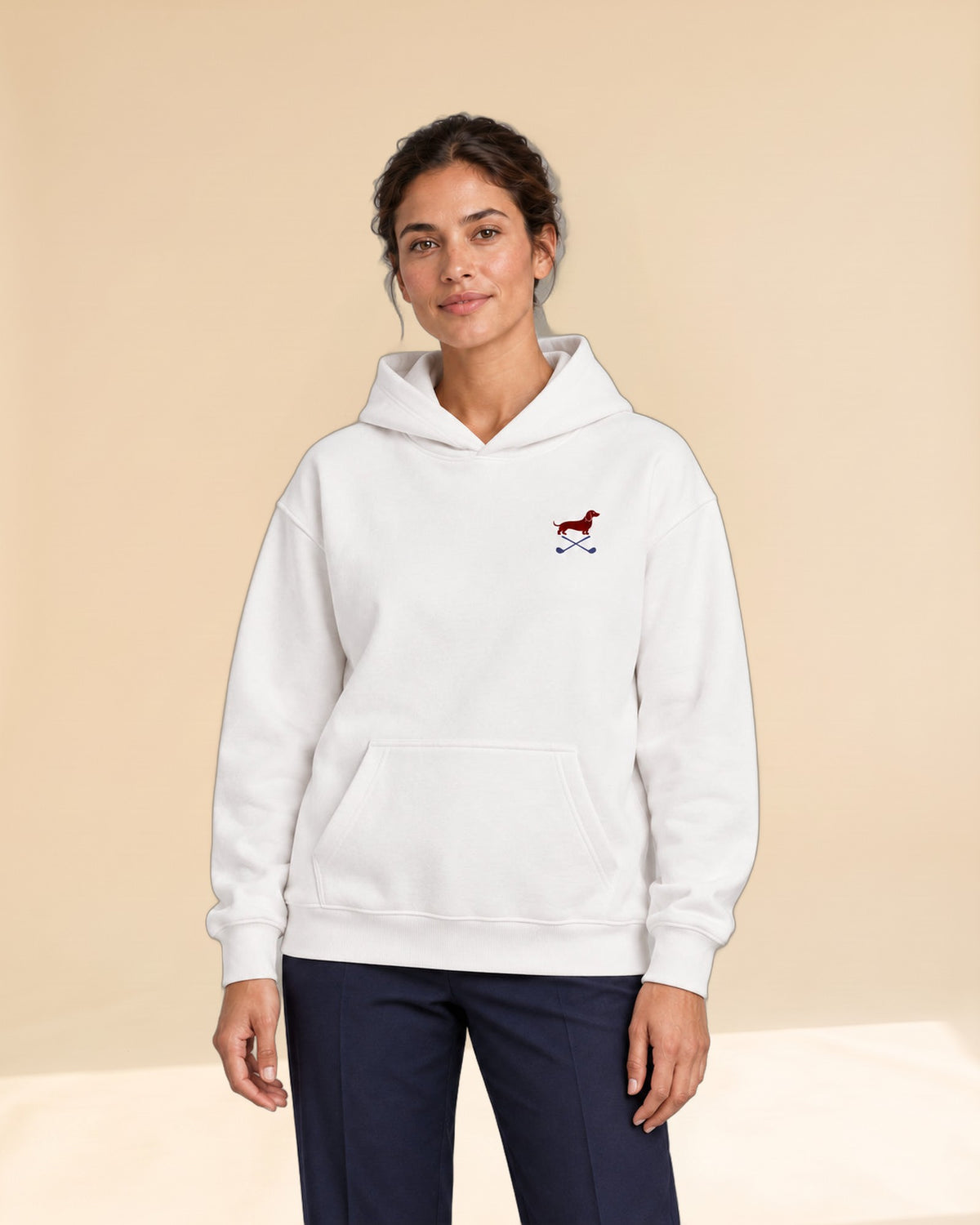 Woman wearing Club & Swing dachshund golf hoodie, front studio view. Color: White