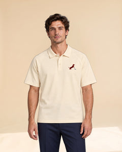 Man wearing Putting dachshund golf polo, front studio view. Color: Apricot