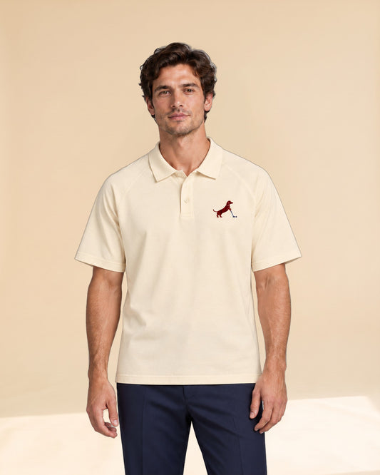 Man wearing Putting dachshund golf polo, front studio view. Color: Apricot