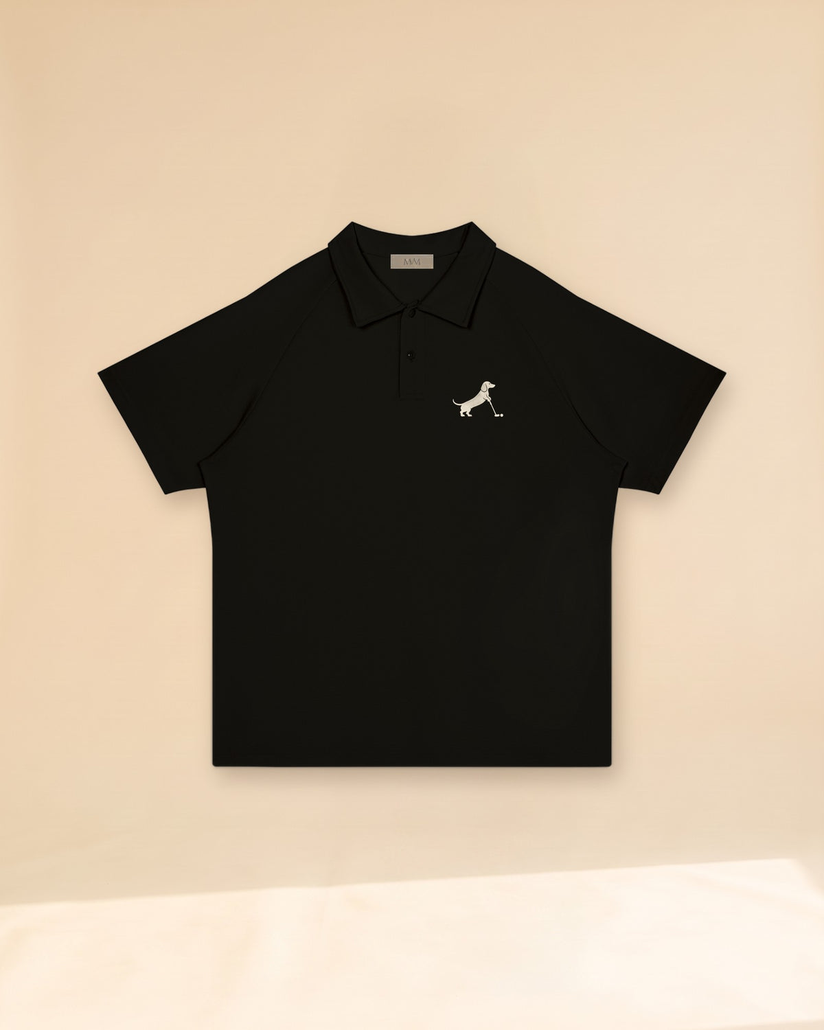 Putting dachshund golf polo, front flatlay. Color: Black