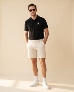 Man wearing Putting dachshund golf polo, full-body studio look. Color: Black