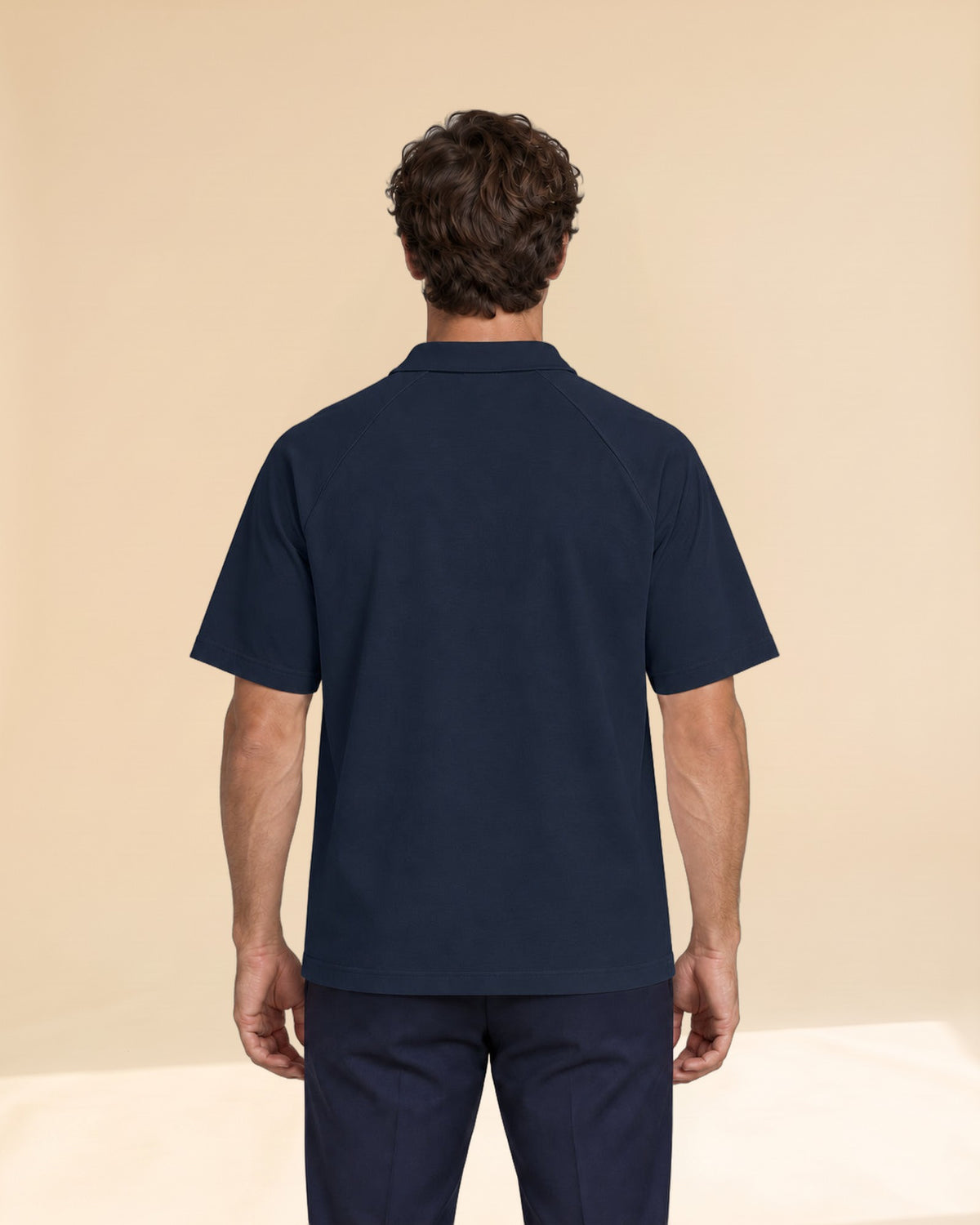 Man wearing Putting dachshund golf polo, back studio view. Color: Navy Blue