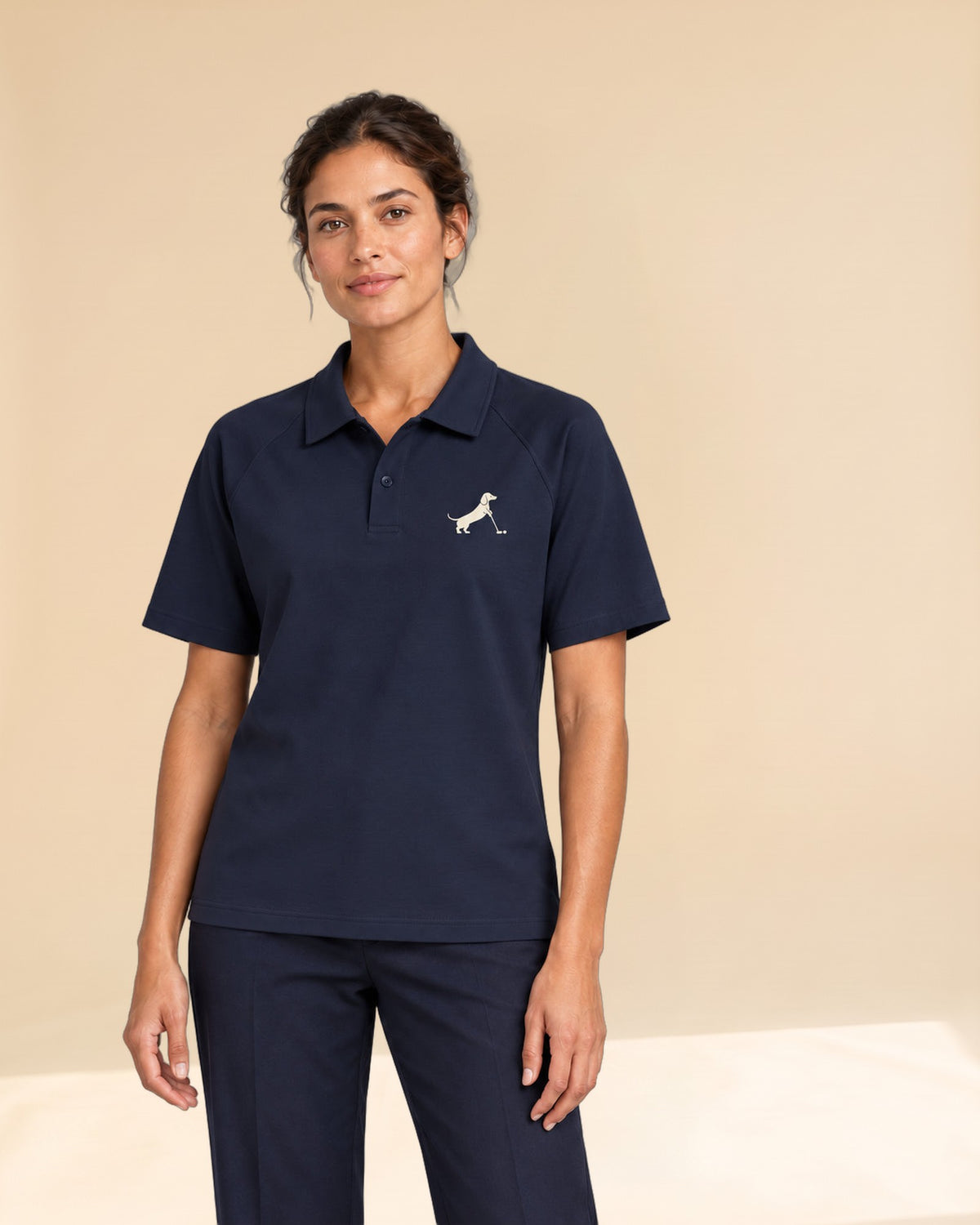 Woman wearing Putting dachshund golf polo, front studio view. Color: Navy Blue